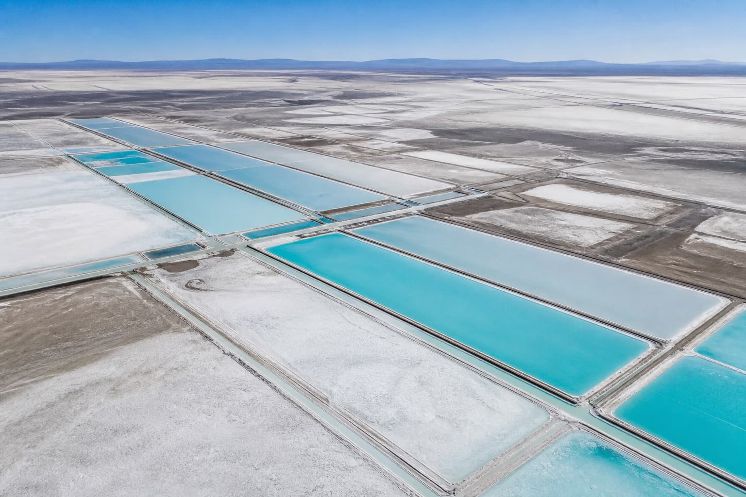 Aerial view of lithium brine ponds beside salt flats